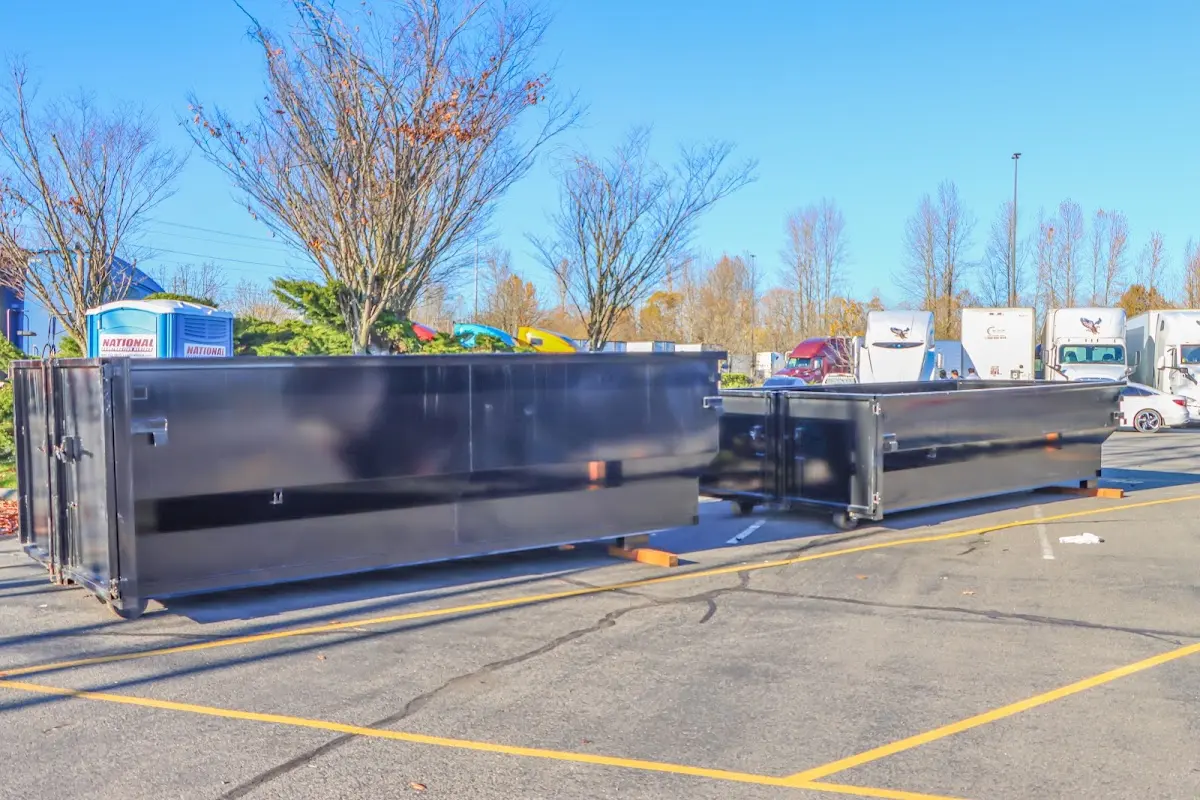 Professional dumpster rental service with roll-off container on residential driveway in Hightstown